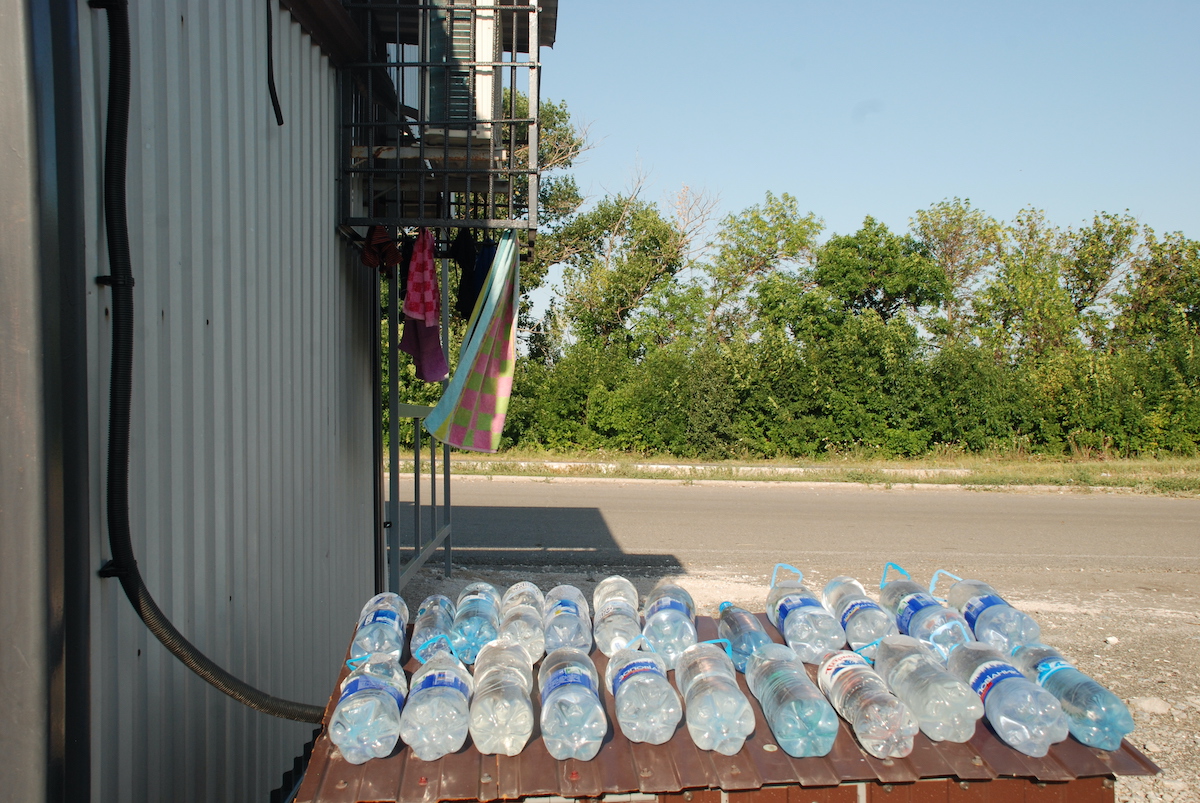 KPVV Novotroitsk. People heat water in bottles in the sun to wash themselves.